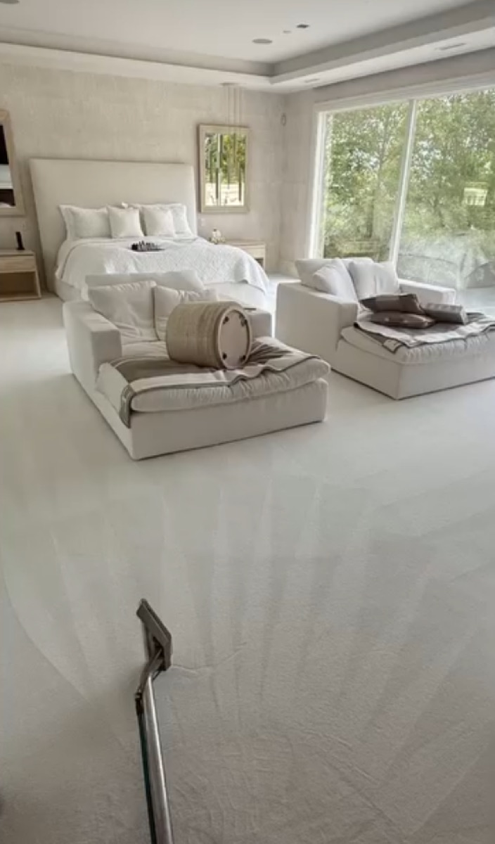 Luxury master bedroom with freshly steam-cleaned cream carpet and extraction wand in a Vancouver home