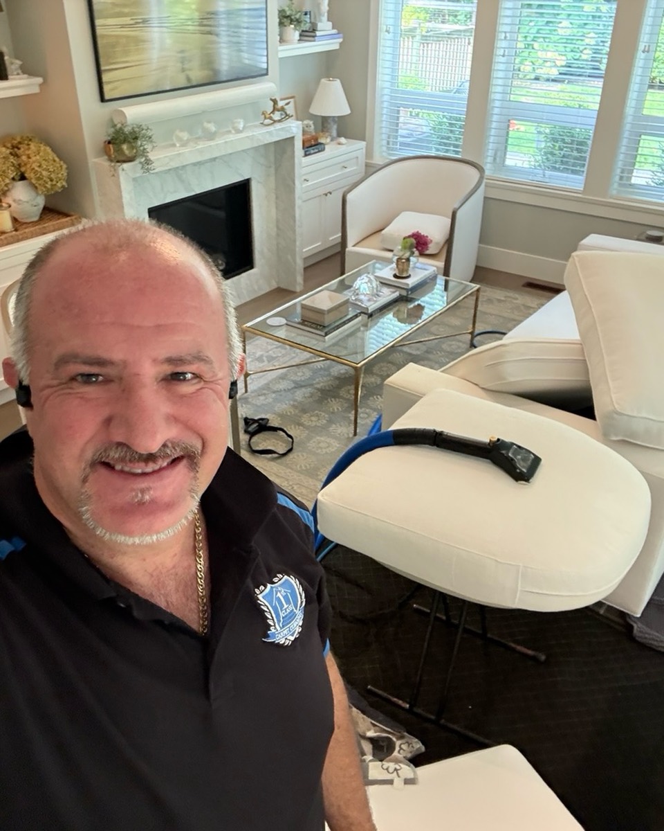 Harry from First Class Carpet Cleaning at work with the cleaning wand in a luxury Vancouver living room