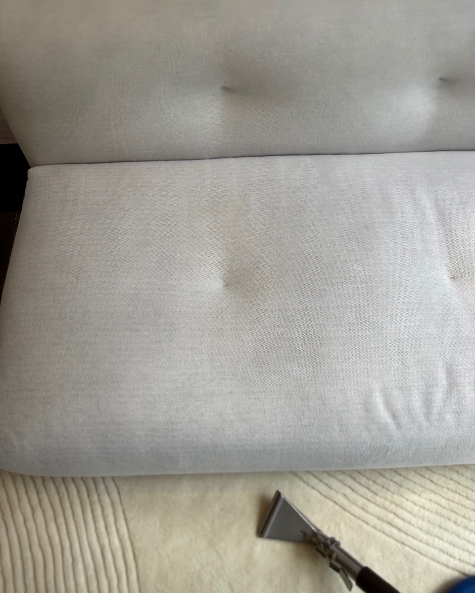 Freshly cleaned cream tufted sofa with an extraction wand — Vancouver upholstery cleaning