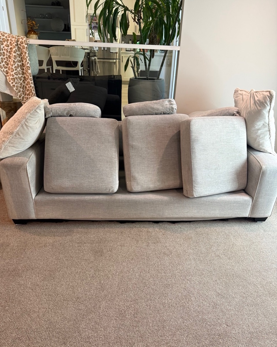 Grey fabric sofa with cushions lifted for deep upholstery cleaning in Vancouver